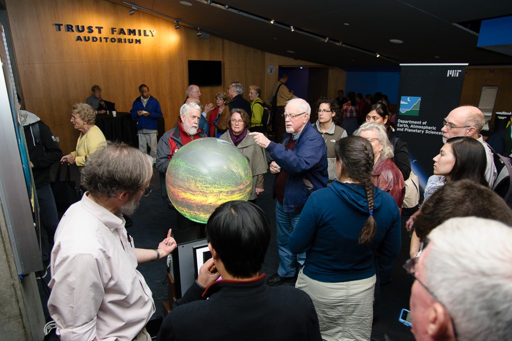 Guests gather around the iGlobe and talk with MIT scientists about atmospheric circulation. Credit: John Gillooly