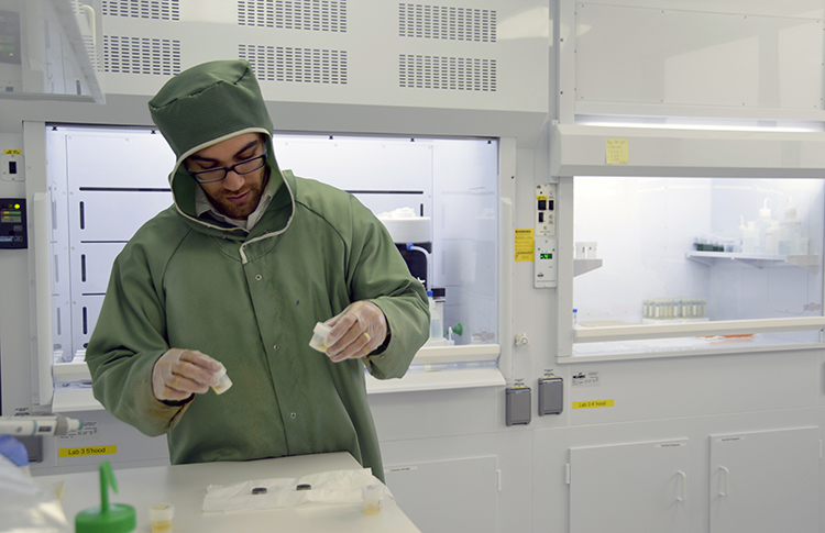 Adam Sarafian preps samples in Sune Nielsen's NIRVANA clean lab to remove all contamination from the surface prior to analysis (Photo: Jayne Doucette, Woods Hole Oceanographic Institution)