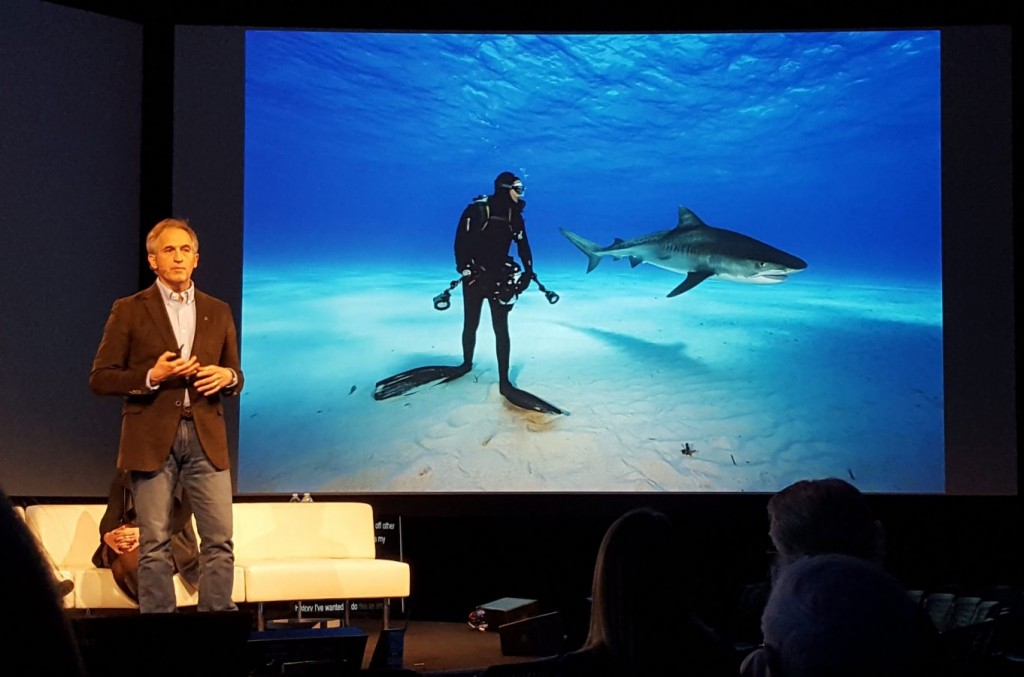 New England Aquarium Explorer in Residence and famous environmental photojournalist Brian Skerry stands next to one of his iconic images.